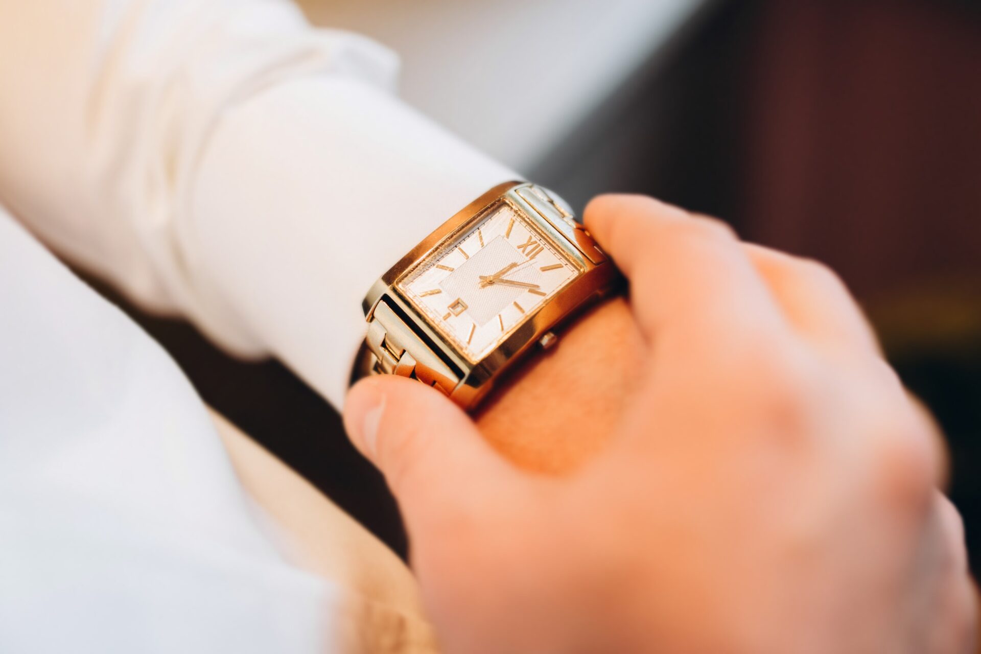 Wristwatch in the hands of a man close-up